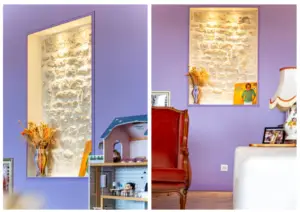 Purple-walled room with a lit stone niche displaying dried flowers in a vase; a toy dollhouse sits below.